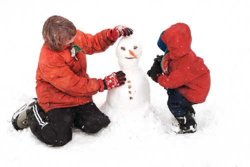 Children building snowman